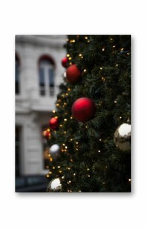Vertical selective focus of a Christmas tree decorated with Christmas baubles