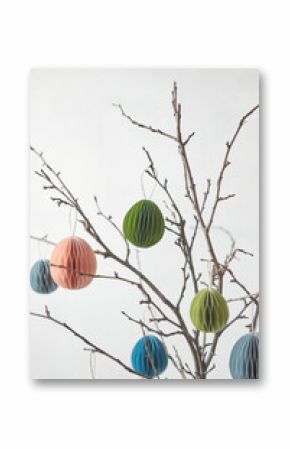 Handicraft paper Easter eggs hung on twigs.