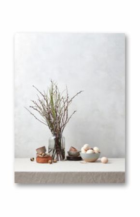 Willow twigs on table with wooden Easter eggs.
