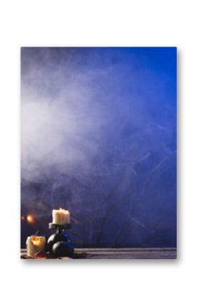 Vertical image of pumpkins and candles with copy space on dark background