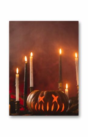 Vertical image of pumpkins and candles with copy space on orange background