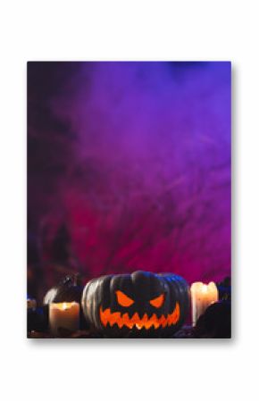 Vertical image of pumpkins and candles with copy space on purple background
