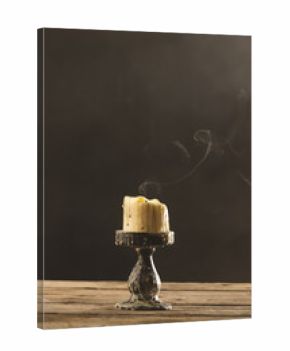 Vertical image of extinguished candle with copy space on grey background