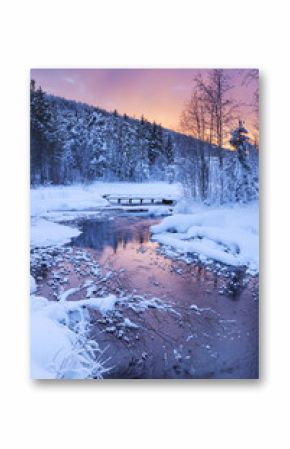 Sunrise over a river in winter near Levi, Finnish Lapland