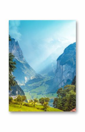 The beautiful landscape of the town Lauterbrunnen in the canyon of the Swiss Alps in the sun rays. Switzerland, Europe