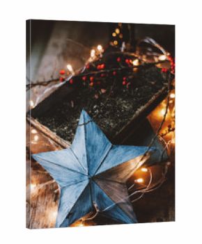 Star ornament with festive lights and books still life