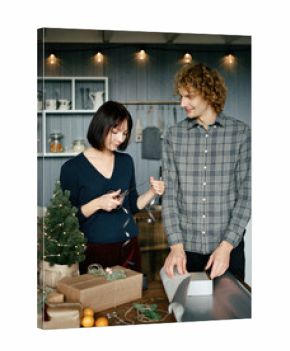 Happy couple wrapping Christmas presents