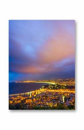 Nightview of the city of Nice, France. The view goes from the foreground with the castle of Nice to the airport in the background.