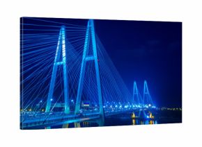 Night panorama to the cable-stayed bridge. Movement of cars on the bridge at night. The long bridge.