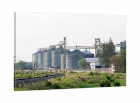food industry building with agricultural silos and railway in the city