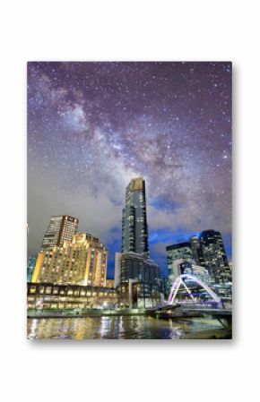 Night city view of buildings along Yarra River, Melbourne. Starry night