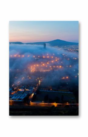 Early morning fog over the rising city of Queretaro Mexico. The aqueduct of Queretaro, is currently building a monumental seventy four arches reaching an average height of twenty eight meters. 