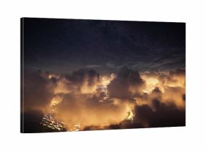 Flying over the deep night clouds with dark sky. Flight through moving cloudscape over night city lights. Perfect for posters, background, digital composition.
