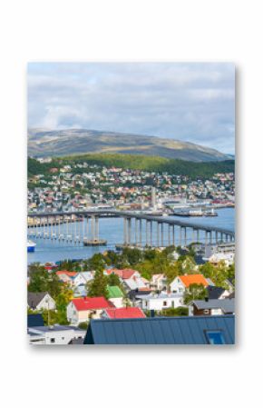 View of Tromso on island of Tromsoya linked across Tromsoysundet strait with Tromsdalen on mainland by Tromso Bridge. Norway