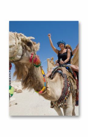 two girls are ride on camel in desert