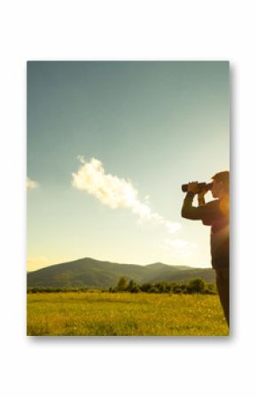 Young Man use of the binocular at forest