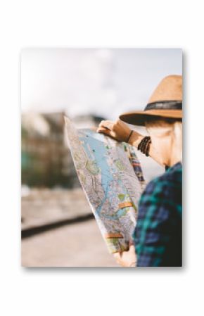 Young tourist woman searching right direction on map