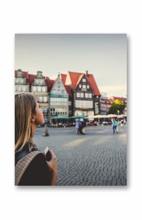 Young lady in dress on medieval street of Bremen, Germany. Trevel destination concept