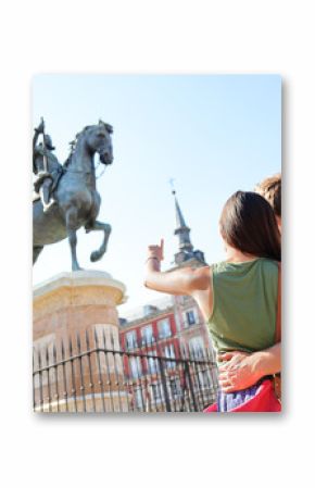 Madrid tourists on Plaza Mayor looking at statue