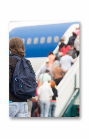 Girl boarding plane, back view