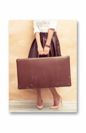 Woman holding retro suitcase 