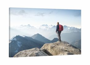 Tourist on the peak of high rocks. Sport and active life concept..