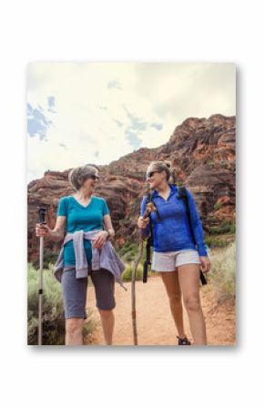 Women hiking together in a beautiful red rock canyon