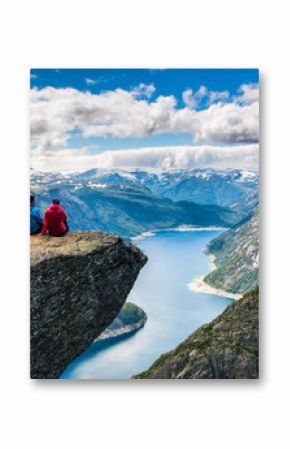 Couple sitting against amazing nature view on the way to Trolltunga. Location: Scandinavian Mountains, Norway, Stavanger. Artistic picture. Beauty world. The feeling of complete freedom