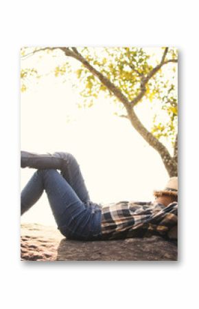Boy backpacker sleeping on the rock in nature , Relax time on holiday concept travel,selective and soft focus,tone of hipster style