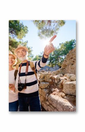 Family, age, tourism and travel concept. Happy senior couple with map at ancient sightseeing.