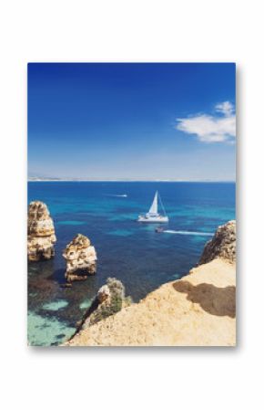 Young woman traveler looking at the sea in Lagos town, Algarve region, Portugal. Travel and active lifestyle concept
