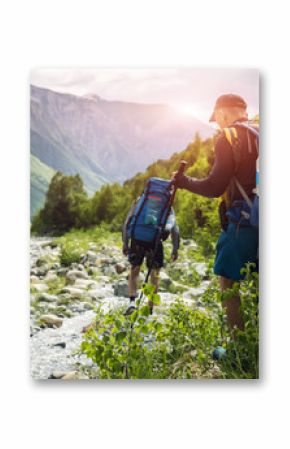 Tourists with hiking backpacks on beautiful mountain landscape background. Climbers hike to mounts. Group of hikers walking in mountains