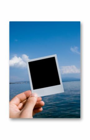 Photo in a hand on nature sea background