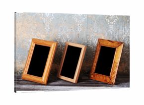 three photo-frames on old table