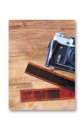 old vintage camera and pictures over wooden background