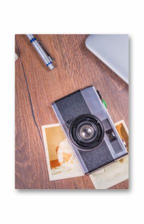 Vintage image with old Camera,old photo,laptop,pen and passport on wood table.