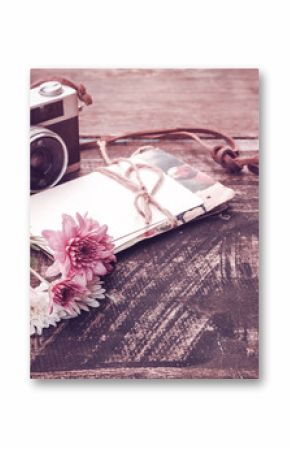 Vintage camera with bouquet of flowers on old wood background - concept of nostalgic and remembrance in spring vintage background