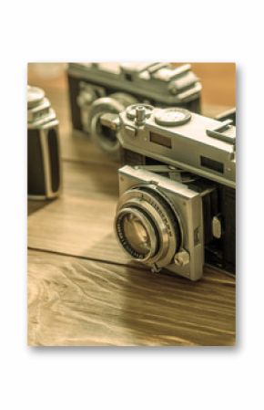 Vintage cameras and lenses on wooden background