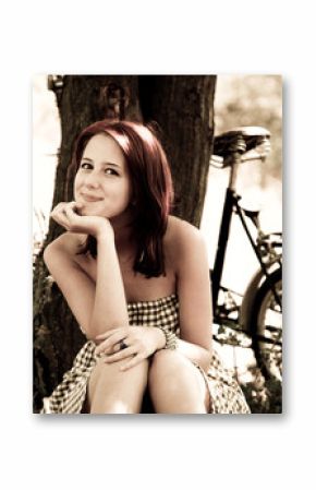 Beautiful girl sitting near bike Photo in retro style.