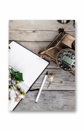 Old vintage black rotary phone and a bouquet of roses