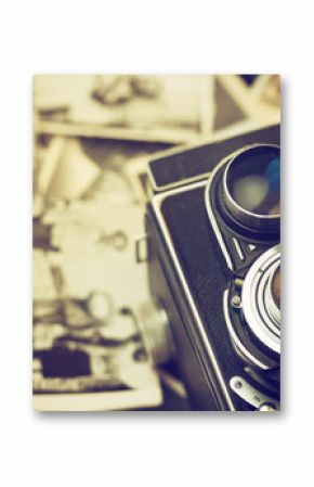 Old camera is lying on vintage family photos