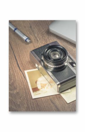 Vintage image with old Camera,old photo,laptop,pen and passport on wood table.