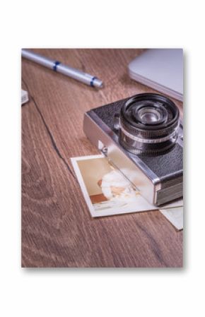 Vintage image with old Camera,old photo,laptop,pen and passport on wood table.