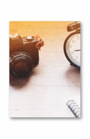 Film camera and alarm clock on wood table, Vintage style object