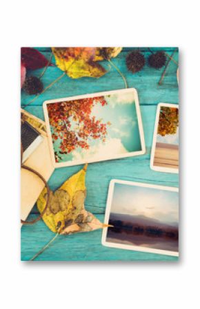 Photo album in remembrance and nostalgia in autumn (fall season) on wood table. instant photo of retro camera - vintage and retro style