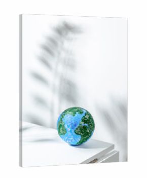 Small globe placed on white table in light room
