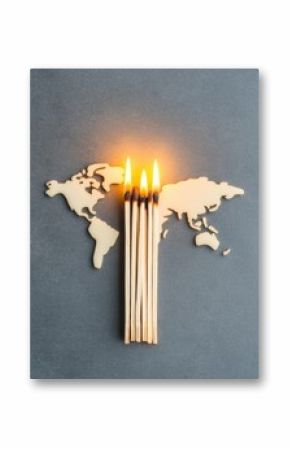 Wooden world map with five burning matches aligned vertically, symbolizing global crisis or environmental issues.