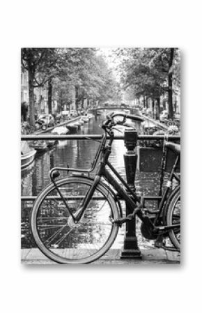 Amsterdam, Holland, May 12 2018: Old bicycle parked on a canal bridge in Amsterdam