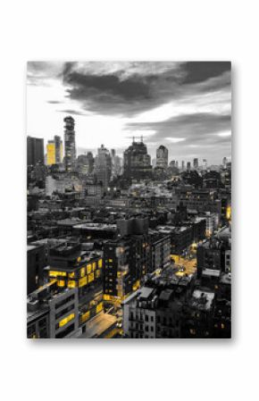 New York City black and white nighttime cityscape with glowing yellow lights in the skyline buildings of downtown Manhattan