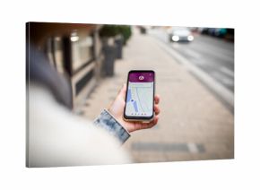 Close up of a young woman using her smartphone to navigate through the city